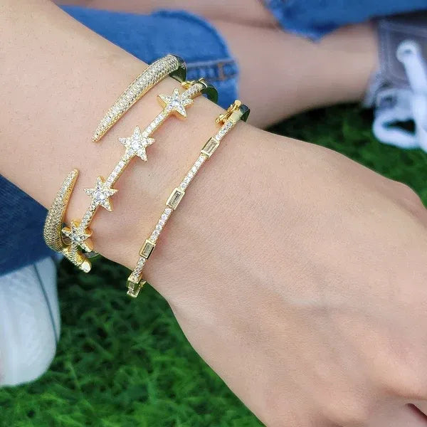 Gold-toned cubic zirconia open cuff bracelet with star accents and pave-set clear stones in a sleek modern design