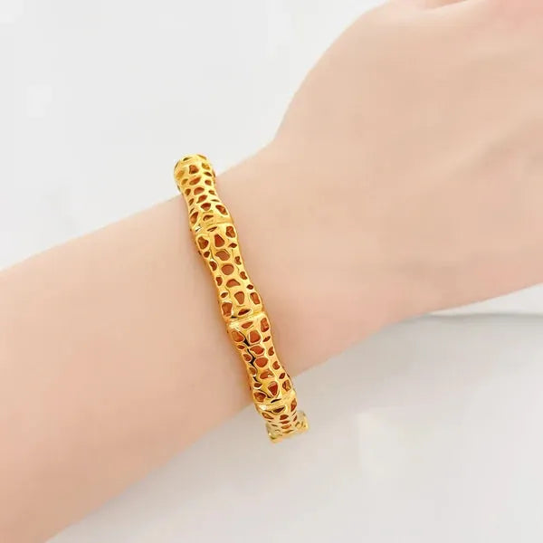 Golden bamboo-inspired sculptural lattice design bangle featuring intricate openwork lattice design for elegance