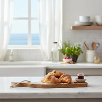 Golden-brown flaky croissants on Whale mango wood cheese cutting board