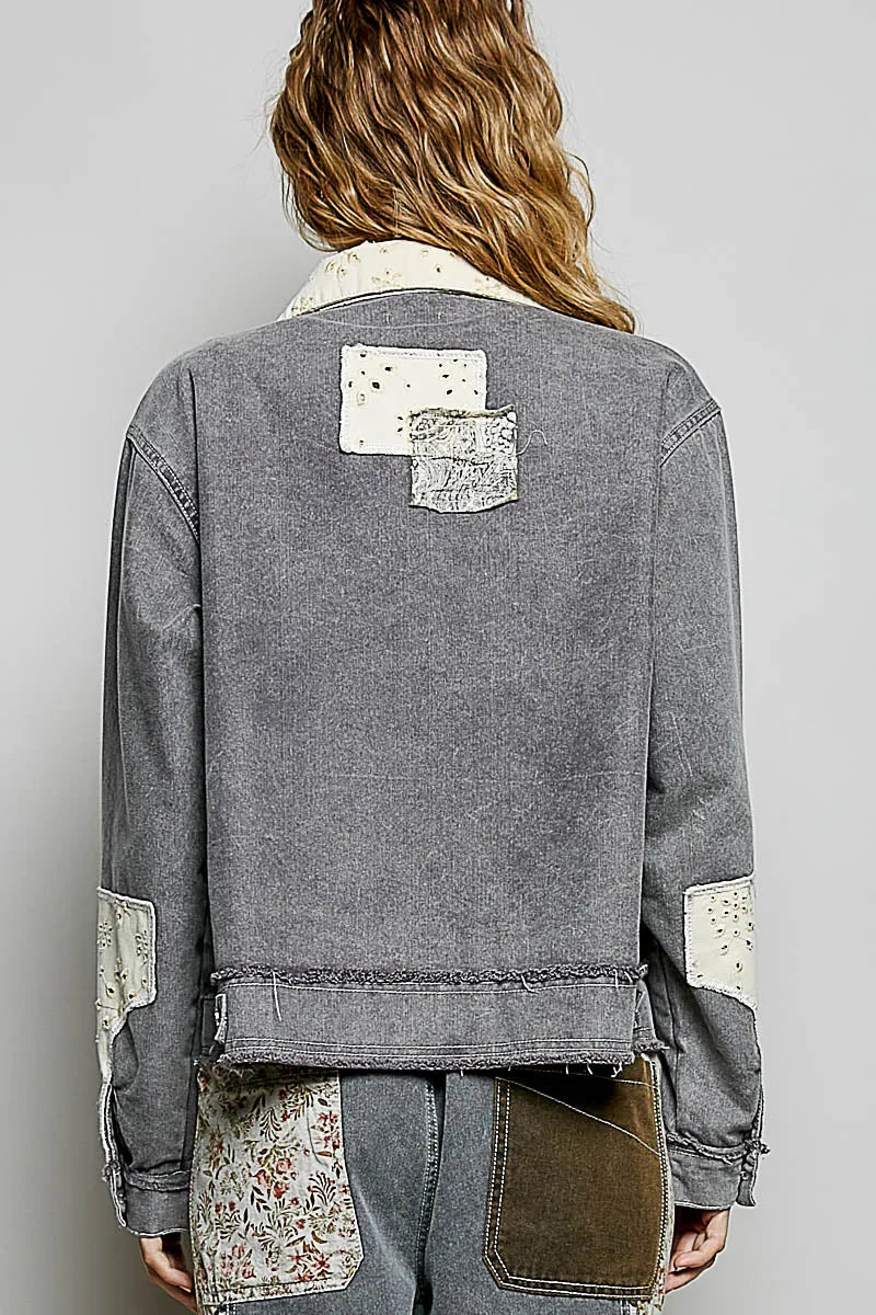 A gray bohemian vintage wash denim jacket with patchwork floral and textured fabric accents