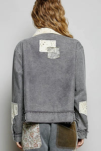 A gray bohemian vintage wash denim jacket with patchwork floral and textured fabric accents