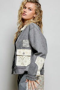 Gray denim jacket with white embroidered patchwork on pockets and sleeves in bohemian vintage wash denim style