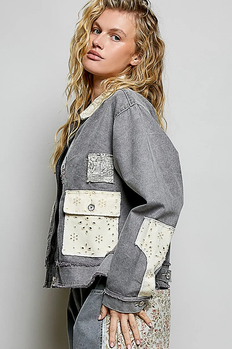 Gray denim jacket with white embroidered patchwork on pockets and sleeves in bohemian vintage wash denim style