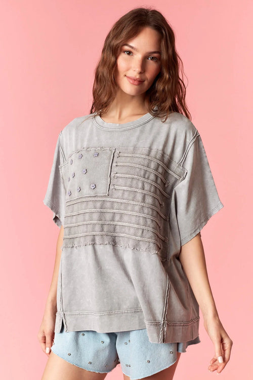 Gray distressed american flag garment dye wash t-shirt with patch pocket and horizontal stitched stripes across front