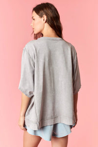 Gray oversized sweatshirt with relaxed fit and subtle distressed texture in american flag garment dye wash style