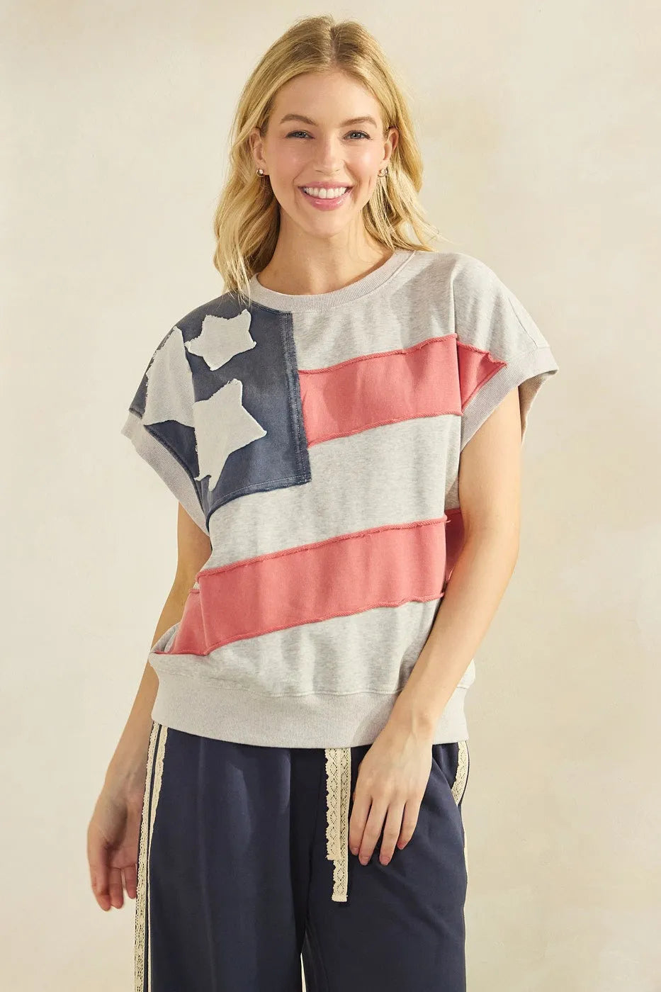 Gray mineral wash sweatshirt featuring an american flag patch design with navy stars and coral pink stripes