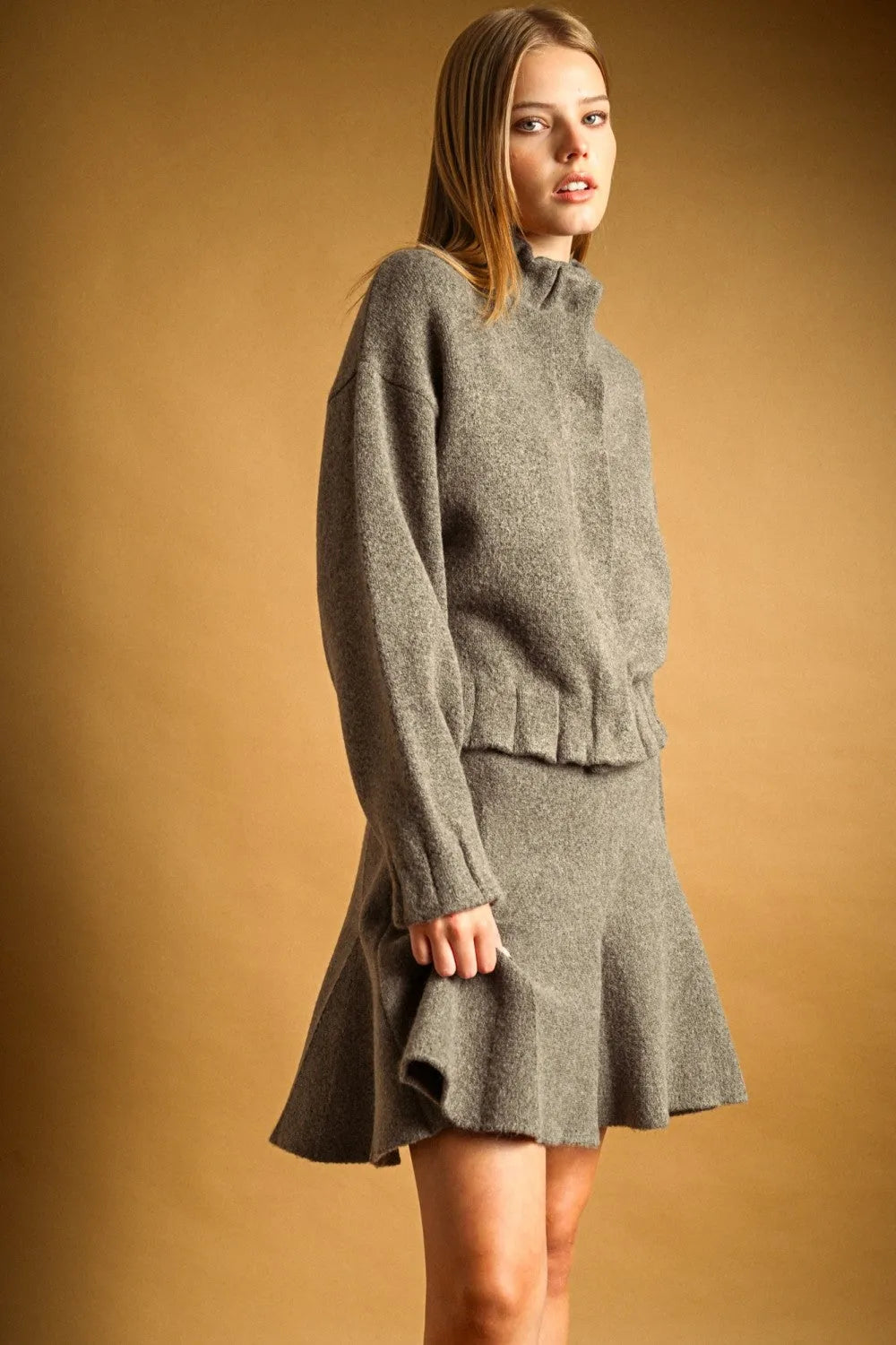 Gray textured knit button closure jacket with high neck button and matching flared skirt featuring ruffled hem