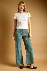 Green floral print stretched wide leg pants with frayed hem made from a comfortable fabric perfect for casual wear