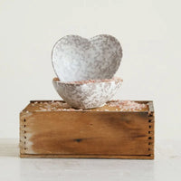 Stoneware heart dish with mottled white and gray glaze nested in a matching bowl filled with pink himalayan salt