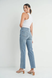 High-waisted full length straight denim jean in light blue wash with subtle fading and distressed details