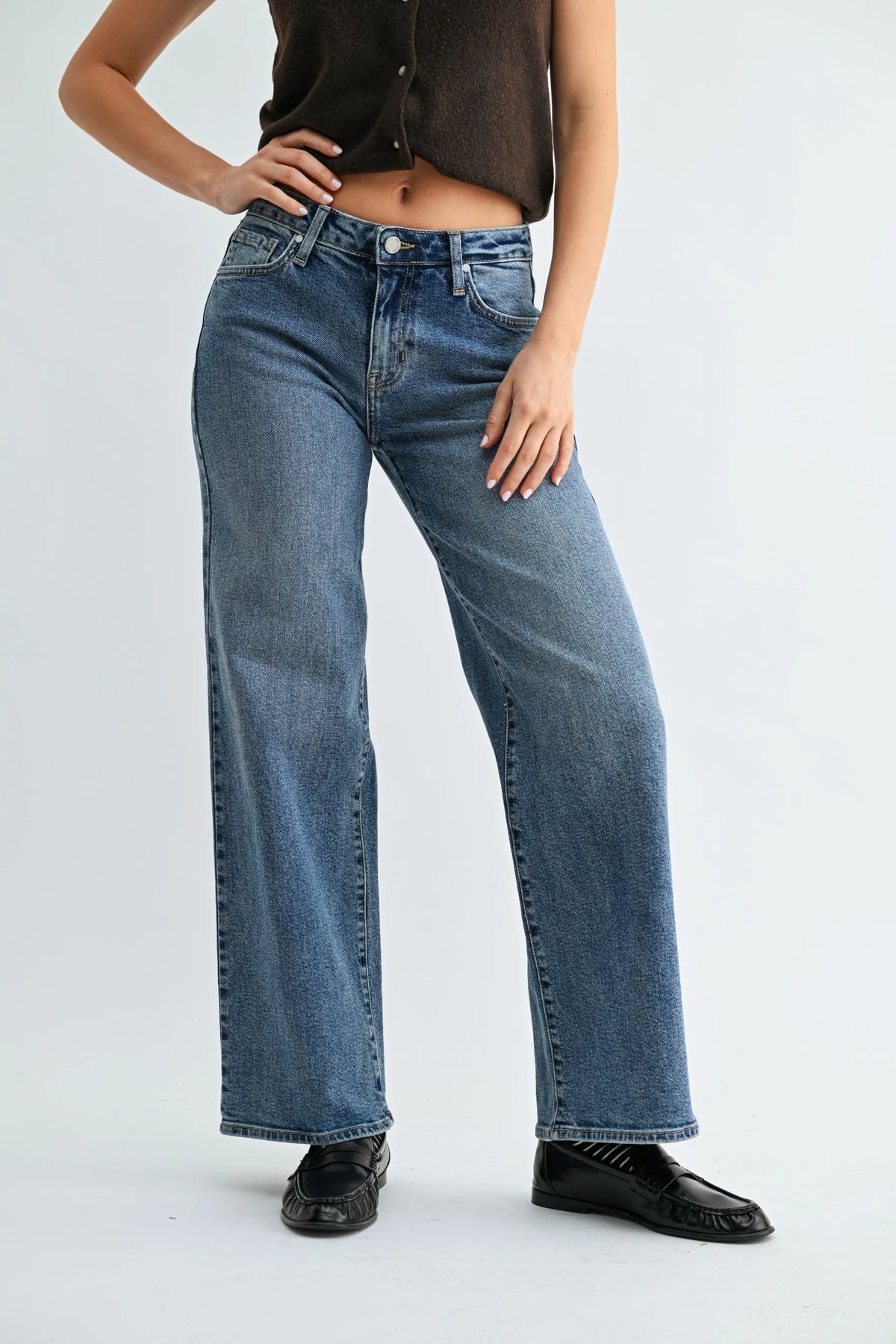High-waisted blue denim jeans with straight-leg cut and five-pocket design featuring low rise mid wash fabric