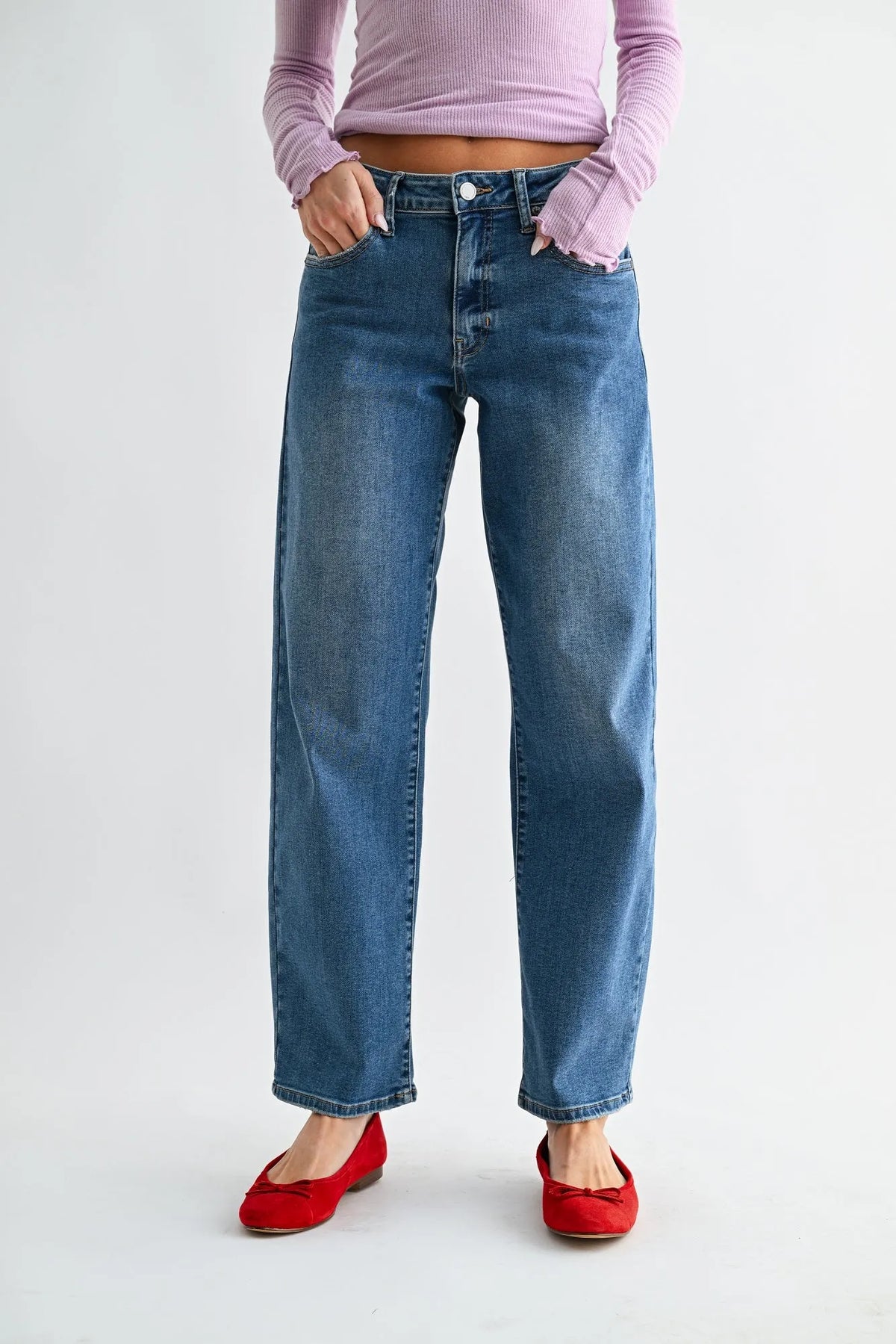 Mid rise bowed straight leg jeans in blue denim with a high waist and frayed cuffs for a casual look