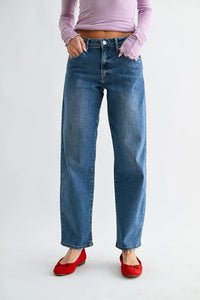Mid rise bowed straight leg jeans in blue denim with a high waist and frayed cuffs for a casual look