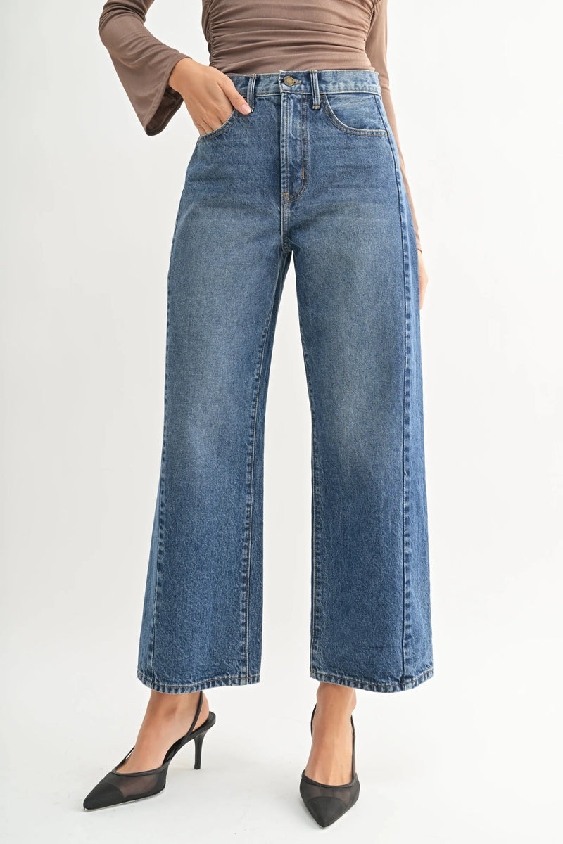 High rise barrel denim jean twist with wide-leg cut and classic stitching in blue denim for women’s boho chic clothing