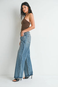 High-waisted light blue denim flare jeans with classic five-pocket design and frayed hem baggy slouchy denim style