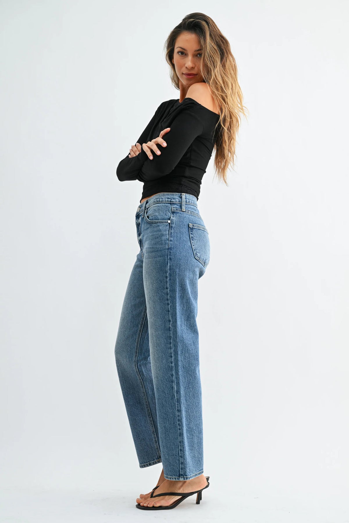 Mid rise classic light blue denim jeans with a high waist and straight leg cut for versatile casual wear
