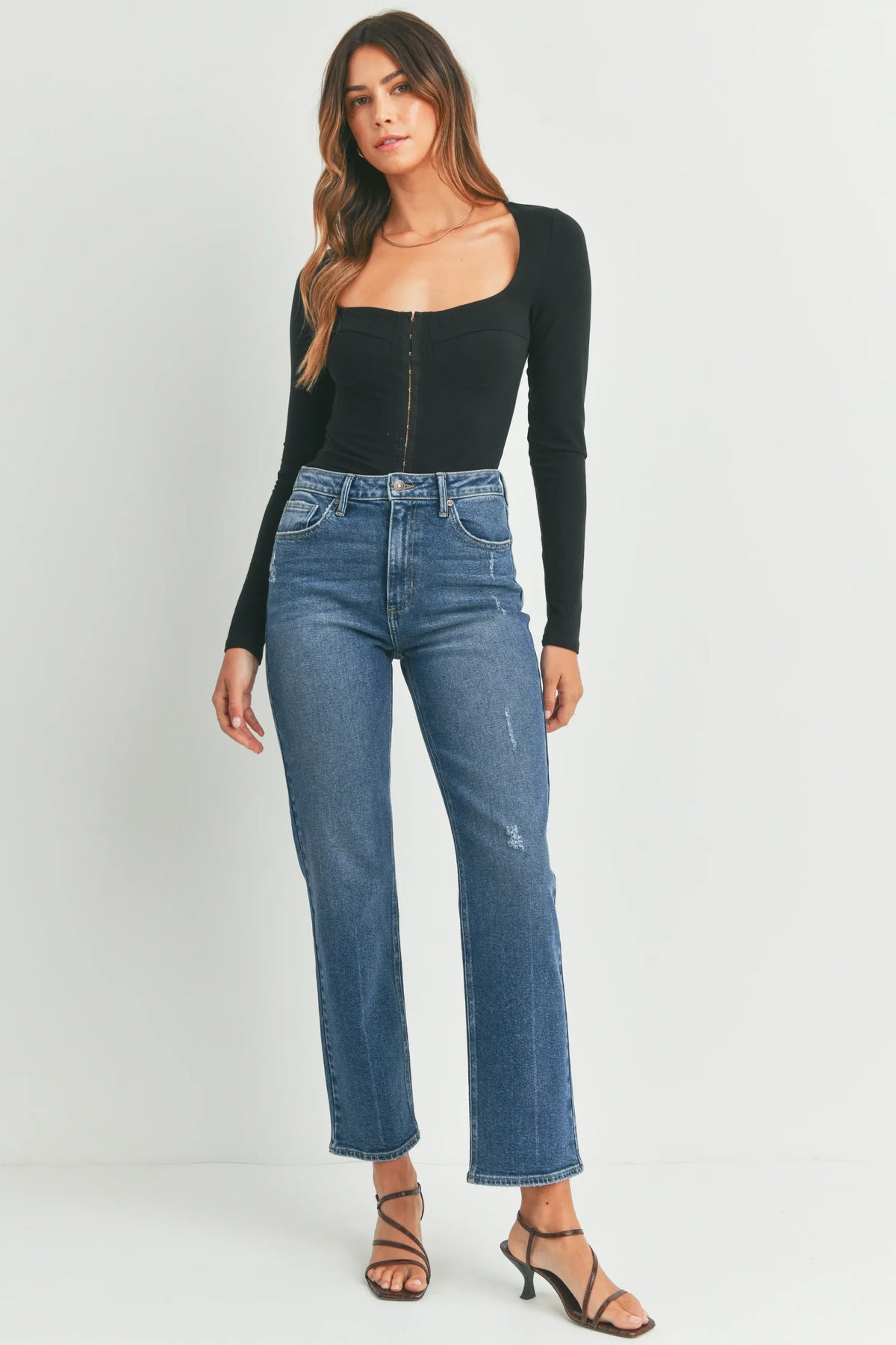 High-waisted full length straight denim jeans in medium blue wash with subtle distressing and classic five-pocket design