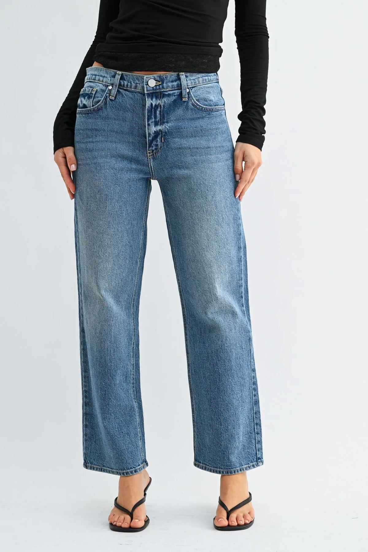 Mid rise classic straight leg denim jeans in medium blue wash with button closure and classic stitching