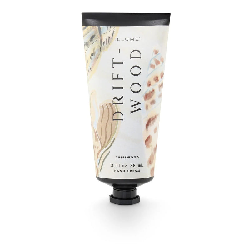 Illume driftwood hand cream in a sleek tube with black cap and watercolor driftwood texture label