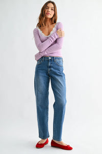 Lavender long-sleeved top with lace trim paired with mid rise bowed straight leg denim jeans in a casual style