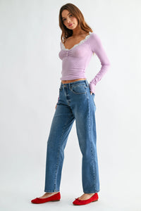 Lavender ribbed long sleeve top with lace trim and gathered front paired with mid rise bowed straight leg jeans denim