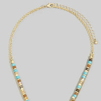 Layered turquoise stone drop bead necklace with gold-toned chain and alternating turquoise and earthy brown square beads