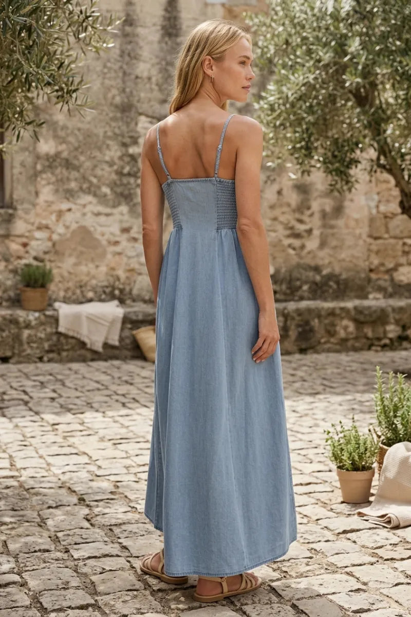 Angel eyes chambray midi dress in light blue denim with thin straps and a gathered waist for a flattering fit