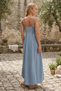 Angel eyes chambray midi dress in light blue denim with thin straps and a gathered waist for a flattering fit