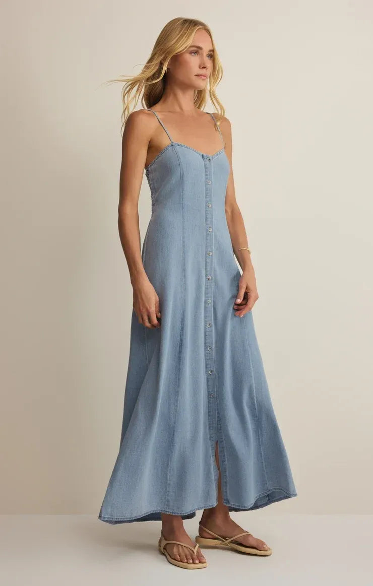 A flowing light blue angel eyes chambray midi dress with thin spaghetti straps and front button closure