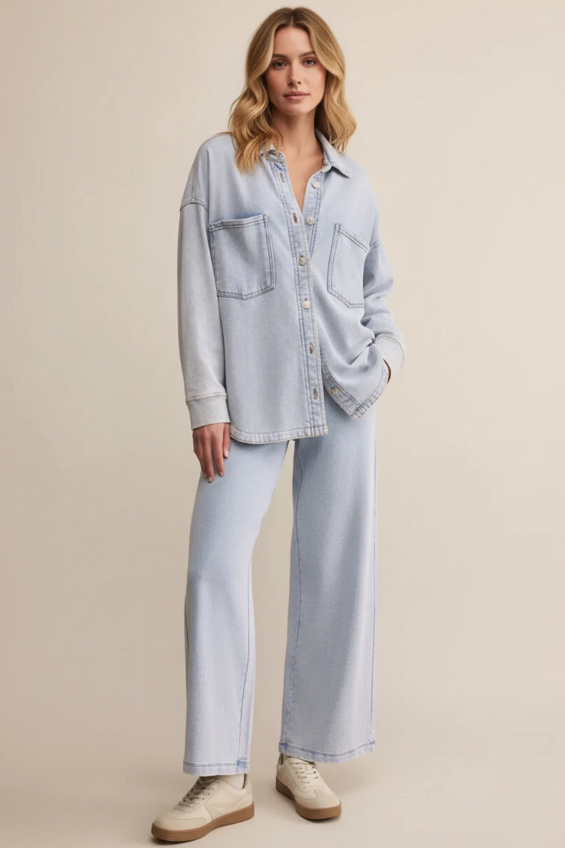 Relaxed fit light wash denim shirt with button-up front, two pockets, rolled cuffs