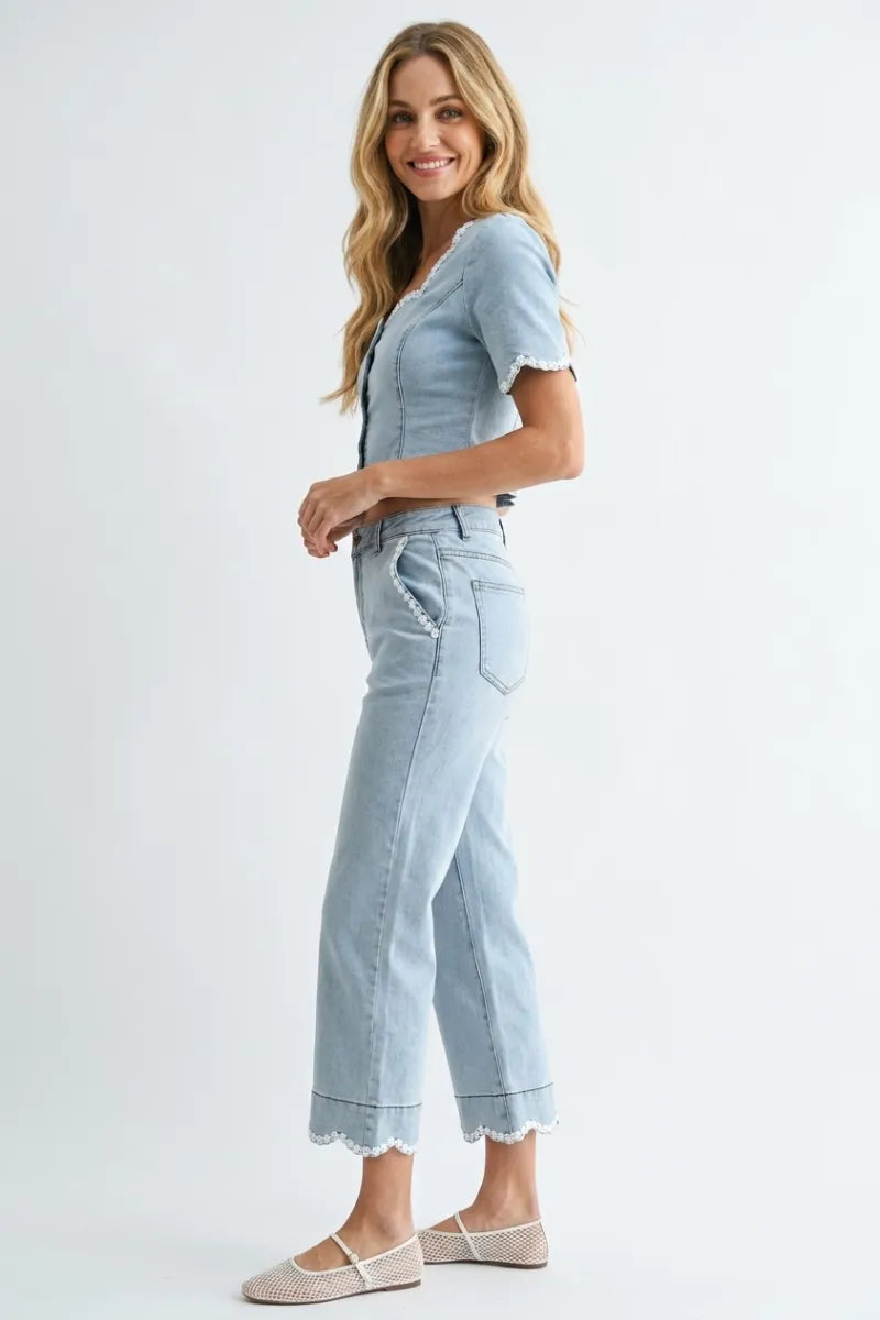 Light blue denim jeans with scalloped hem cropped wide-leg cut and delicate floral trim at the cuffs