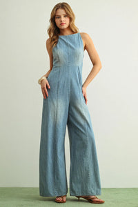 Light blue sleeveless spaghetti strap chambray jumpsuit with high neckline and wide-leg design