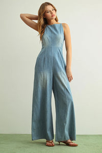 Light blue spaghetti strap chambray jumpsuit with wide-leg design and subtle faded effect