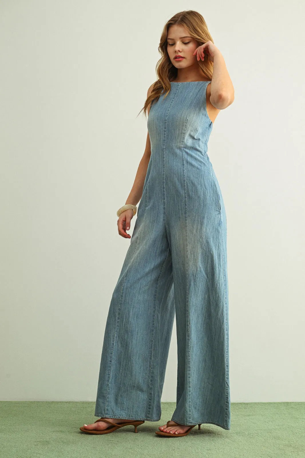 Light blue spaghetti strap chambray jumpsuit with wide-leg design and sleeveless square-neck cut
