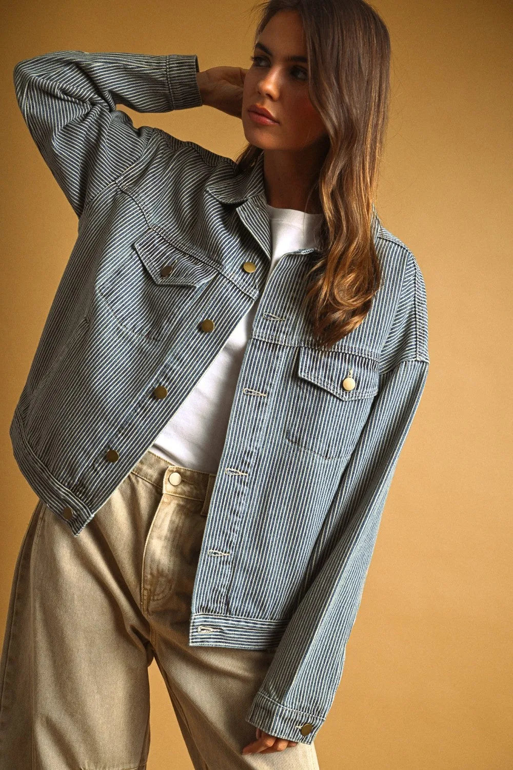 Light blue striped pattern denim jacket with thin white vertical stripes and gold-tone buttons in denim material