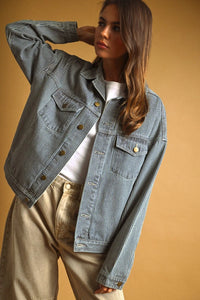 Light blue striped pattern denim jacket with thin white vertical stripes and gold-tone buttons in denim material