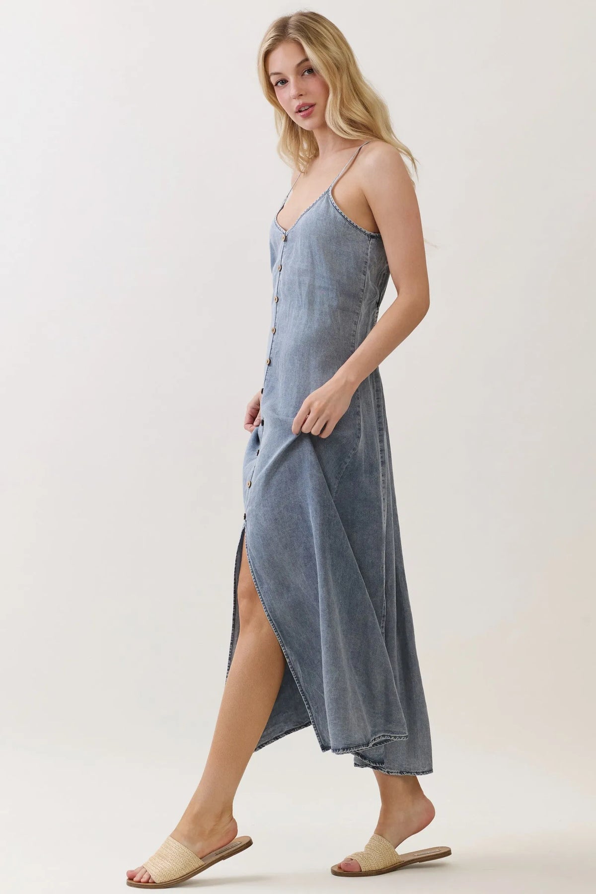 Light blue denim tencel flowy maxi dress with thin straps and front button closure for elegant wear