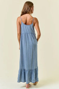 A light blue tencel tiered ruffled midi dress with thin straps and a ruffled hem for elegant wear