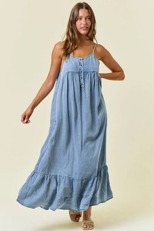 A flowing light blue tencel tiered ruffled midi dress with thin spaghetti straps and a tiered ruffle hem