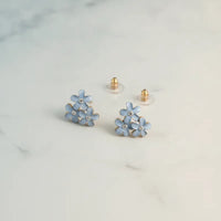 Dainty blue floral enamel stud earrings with clear crystal centers and gold-tone posts for elegant wear