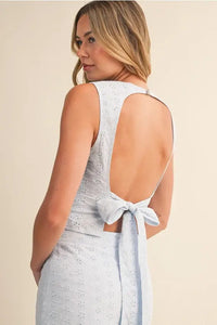 Back view of eyelet open tie back sleeveless top in light blue