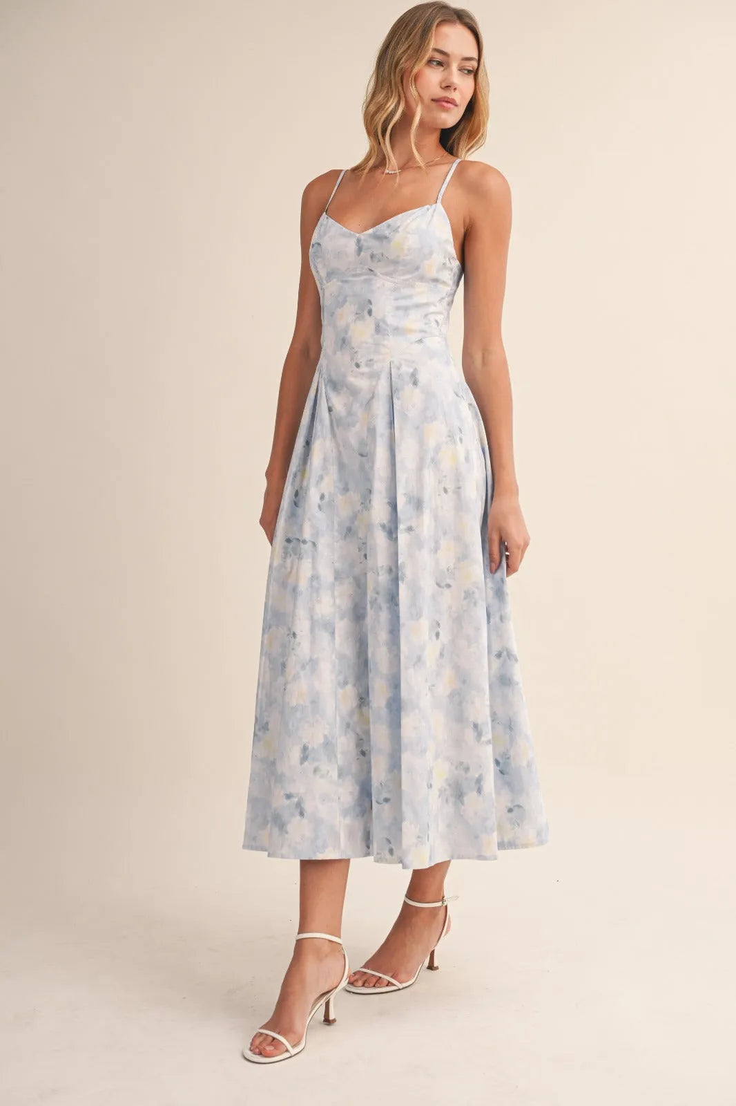 A flowing light blue floral bustier sleeveless flare midi dress with delicate straps and fitted bodice