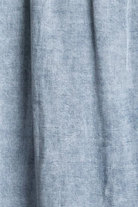 Light blue heathered denim tencel flowy maxi dress fabric with soft textured weave for comfortable wear