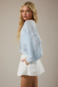 Light blue long sleeve crochet cardigan with intricate lace pattern and ribbed cuffs for elegant layering