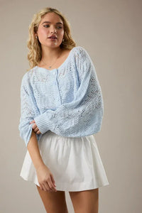 Light blue long sleeve crochet cardigan with intricate knit, button front, and wide sleeve crochet design