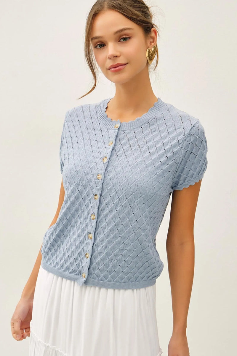 Light blue knitted pointelle stitch short sleeve cardigan with diamond pattern texture and gold toned buttons