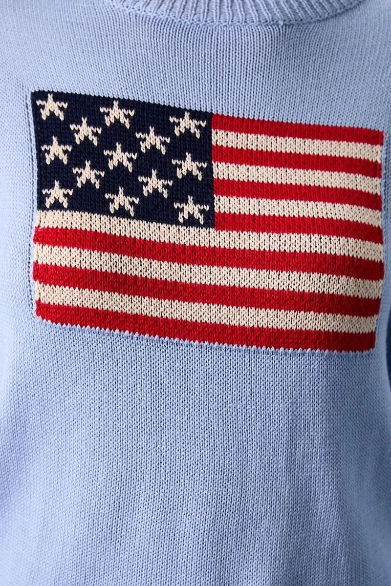 Light blue knitted round neck flag print sweater top featuring a prominent american flag patch in red white and navy blue