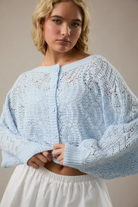 Light blue long sleeve crochet cardigan with intricate lace patterns and button closure open front design