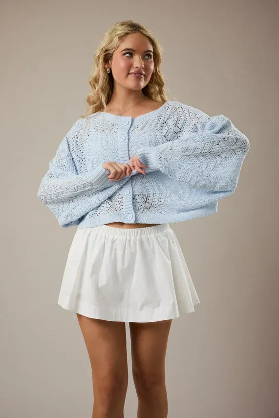 Light blue oversized long sleeve crochet cardigan with delicate lace pattern and button front closure