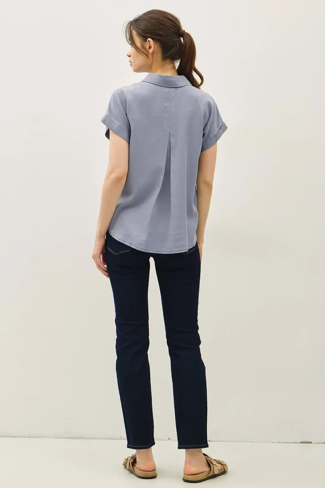 Light blue short dolman sleeve button shirt showing back with subtle pleat for casual and office wear